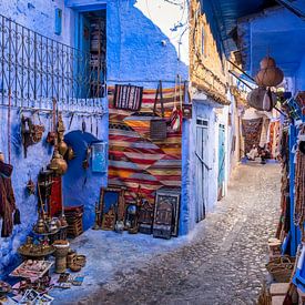 Two men stand talking on the streets of Chefchaouen