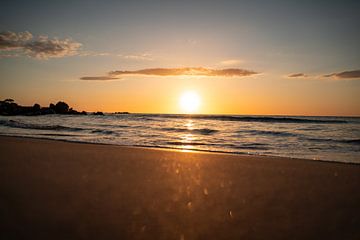 Sunrise on the beach on the coast of Sardinia with glittering sea by Leo Schindzielorz