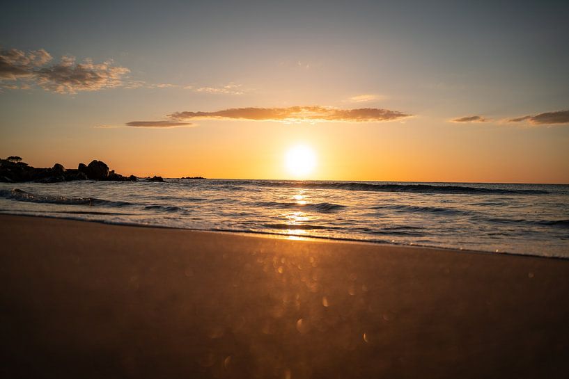 Sunrise on the beach on the coast of Sardinia with glittering sea by Leo Schindzielorz