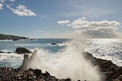 spray of a wave on a rocky beach