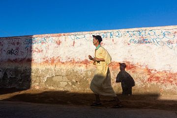 Moroccan man running through streets