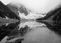 Lake between misty mountains