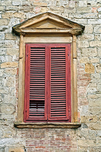 Italian charm – weathered shutters against an old stone wall