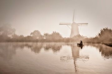 Fisherman in front of a windmill in the morning mist by Frans Lemmens