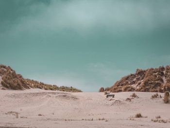 Bench in the dunes of Ameland with a blue sky