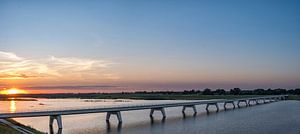 Panoramic view over a bridge over the Reevediep lake during sunset