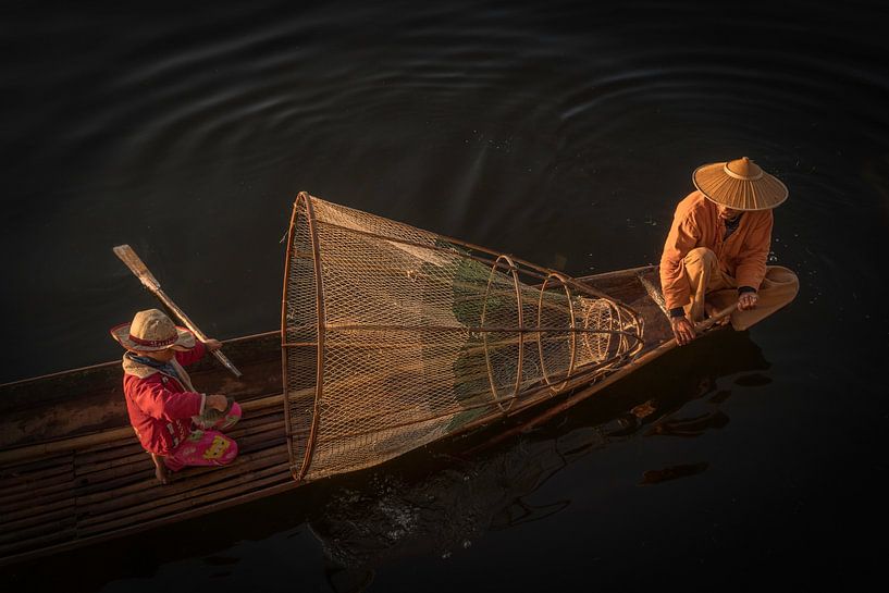 Fisherman with his son on Inle Lake in Myanmar by Anges van der Logt