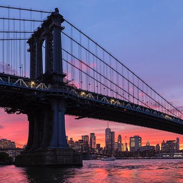 Skyline of Manhattan and Manhattan Bridge at sunset, New York, USA by Markus Lange