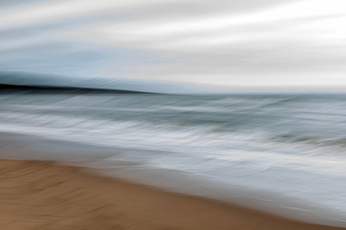 The sea, the sky and the beach on a dark day