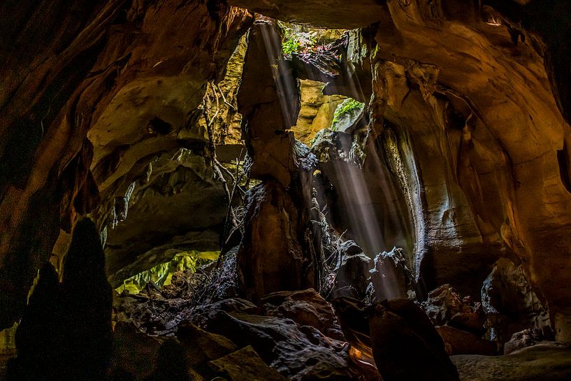 Cave with light beams Sumatra by Corrine Ponsen