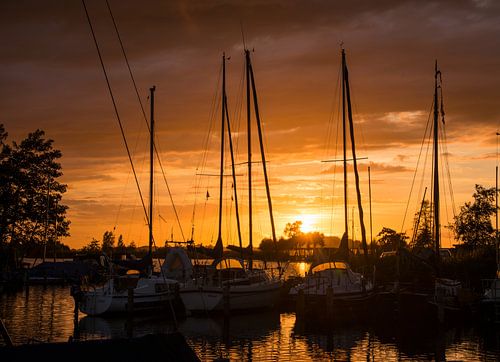 sunset in the harbor of de veenhoop in holland
