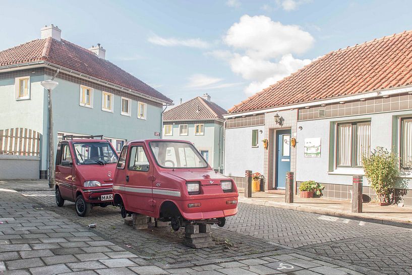 Two red mopeds by Andrew van der Beek