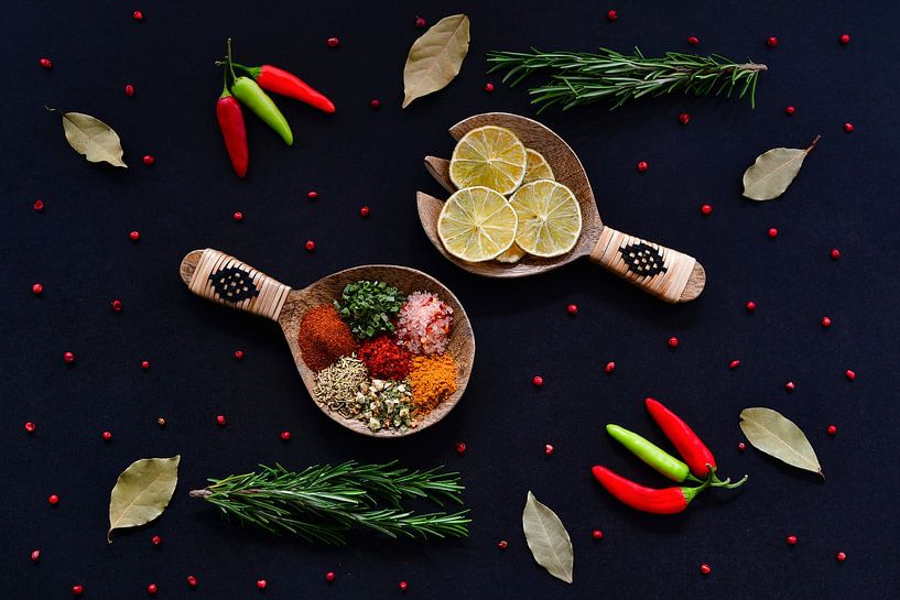 Herbs and spices on wooden spoons by Francis Dost