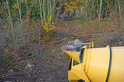 Bouwvoertuigen en -materiaal brengen een betonnen ring aan op een oude graanelevator.