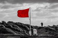 Red storm flag on the south pier and threatening clouds