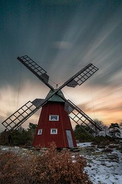 Typische rode Zweedse windmolen in de sneeuw van Fotos by Jan Wehnert