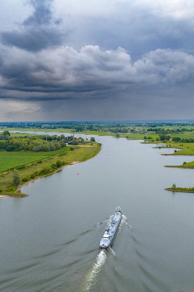 Ship on the river Lek river with rain clouds above by Sjoerd van der Wal Photography