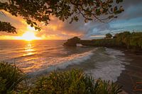 Bali Indonesia, Temple on rock by ocean with sunset