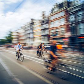 Cyclists on the move through Amsterdam by But First Framing