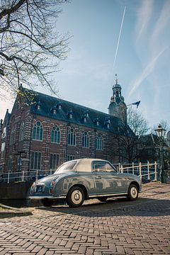Blue Nissan Figaro on the Rapenburg - vintage charm in historic Leiden by Studio Ajuut