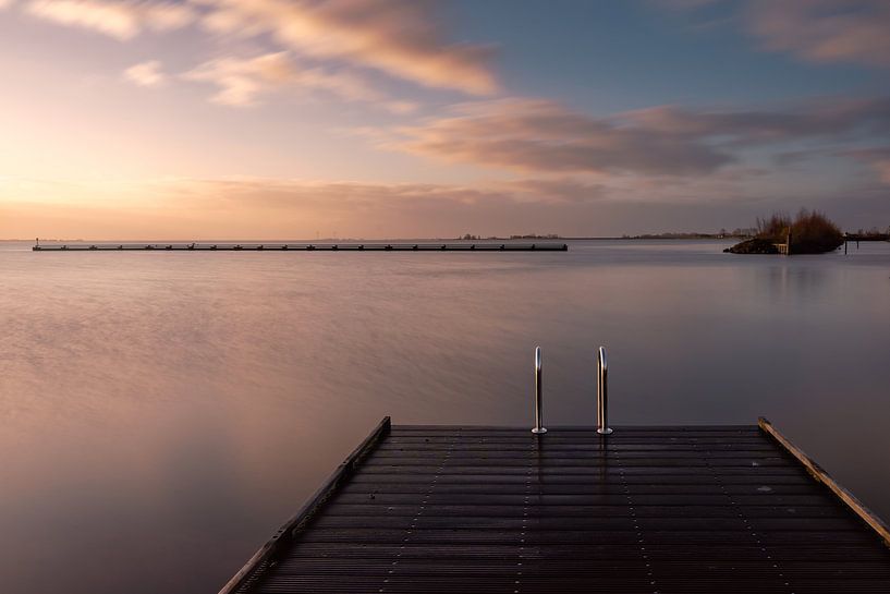Sunrise on the ijselmeer with a jetty in the foreground by Jolanda Aalbers