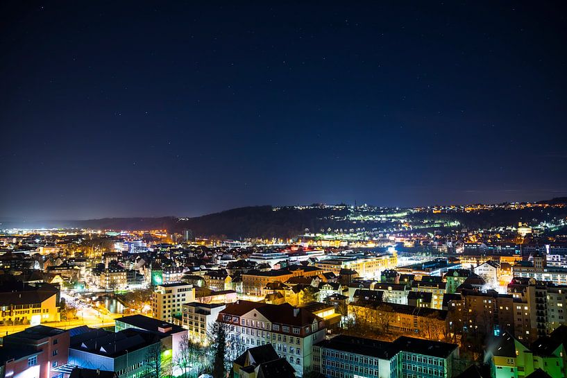 Germany, Dark starry sky over old town buildings of medieval city by adventure-photos