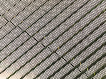 Aerial view on a solar farm producing clean renewable electricity by Sjoerd van der Wal Photography