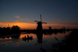 Windmills in Holland (Kinderdijk) against de sunset by Birgitte Bergman