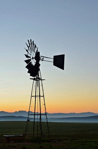 Windmill water pump at sunrise by Werner Lehmann