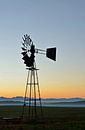 Windmill water pump at sunrise by Werner Lehmann thumbnail