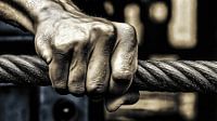 Strong hand grips steel cable