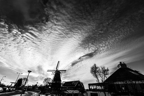 Hollands landschap met hoge schaapjeswolken molen winter zonondergang