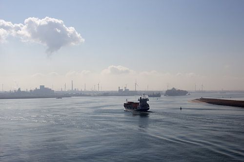 a coaster at dusk heading out to sea