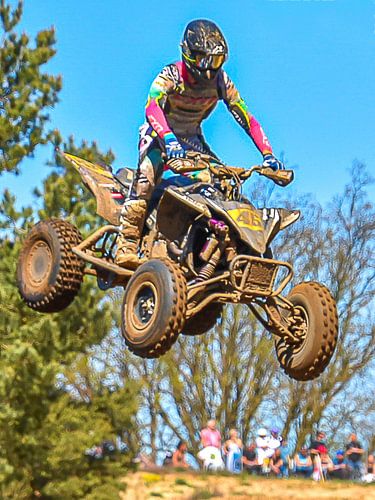 A racing quad bike in mid-air