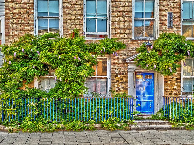 Typical English house facade with blue door by Jos van den Berg
