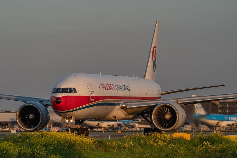 Boeing 777F of China Cargo Airlines in beautiful evening light taxies via taxiway Q to one of the ru by Jaap van den Berg