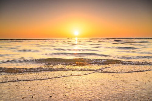 Coucher de soleil sur la plage de la mer du Nord lors d'une journée calme en Hollande méridionale