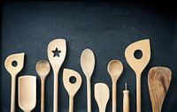 Wooden kitchen tools on a chalkboard