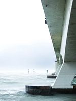 The beautiful zeeland bridge pictured in a different way during a bleak spring storm.