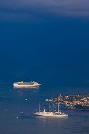 far in the blue distance, the sea mixes with clouds two ships in the bright blue sea and a little gi by Michael Semenov