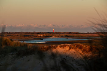Uitzicht over De Slufter en Vuurtoren Texel bij zonsondergang op de Waddeneilanden