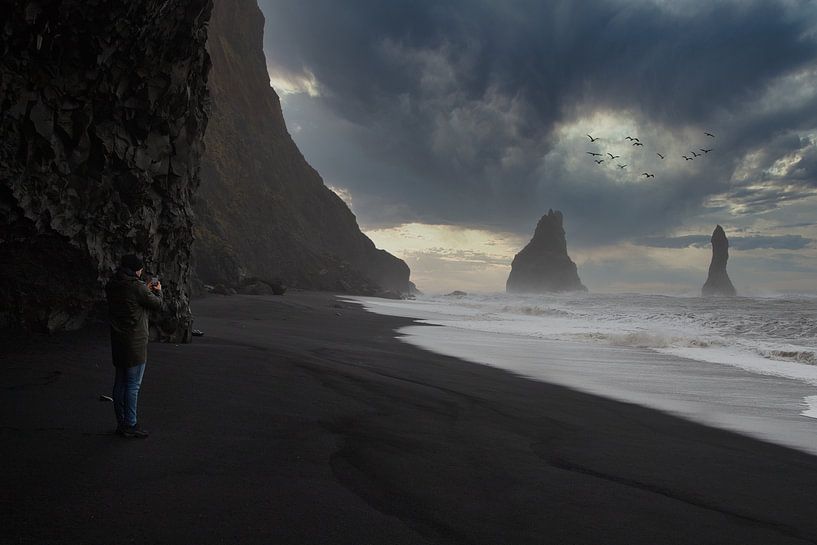 tourist on black beach in iceland by peterheinspictures