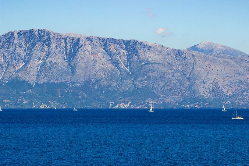 Blue seascape with sailboats and mountains in the background by Edith Keijzer