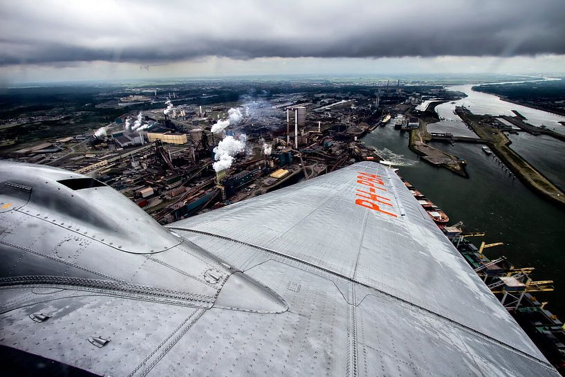 classic DC-3 plane flying over Tata Steel IJmuiden (Hoogovens) by Jeffrey Schaefer