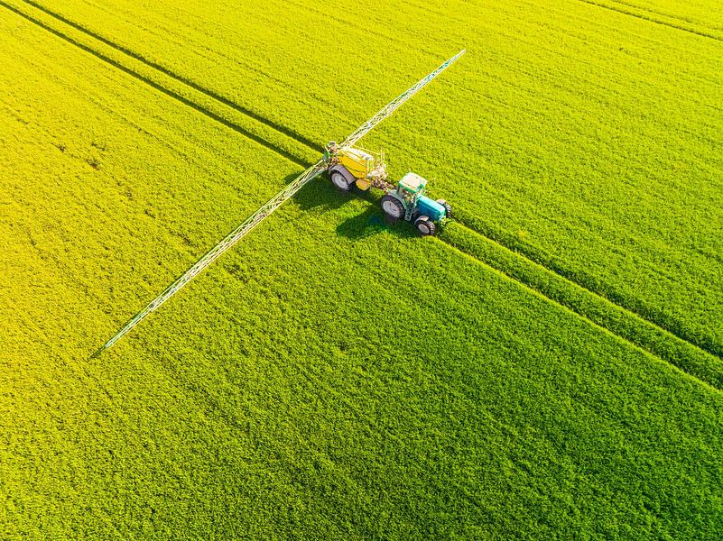 Trekker met landbouw sproeier voor gewassen in een veld van boven van Sjoerd van der Wal Fotografie