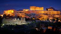 The acropolis of Athens in Greece lit by artificial light against a twilight deep blue sky