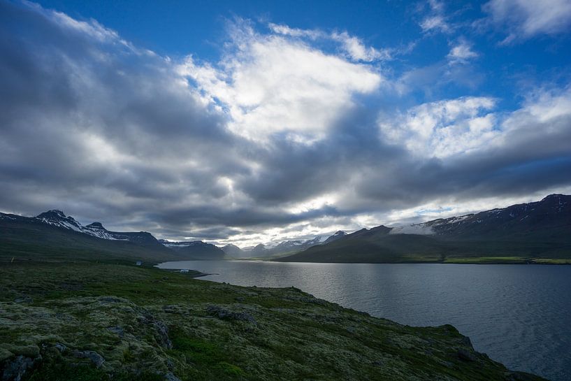 Iceland - Magic atmosphere at fjord surrounded by snowy mountains by adventure-photos