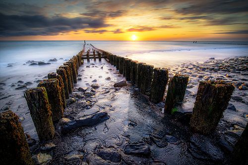 Breakwater at sunset on the Zeeland coast
