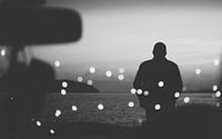 Silhouette traveler on the background of the water in evening