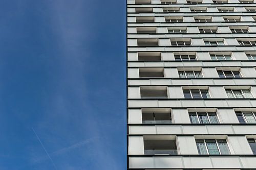 two-part apartment building and blue sky